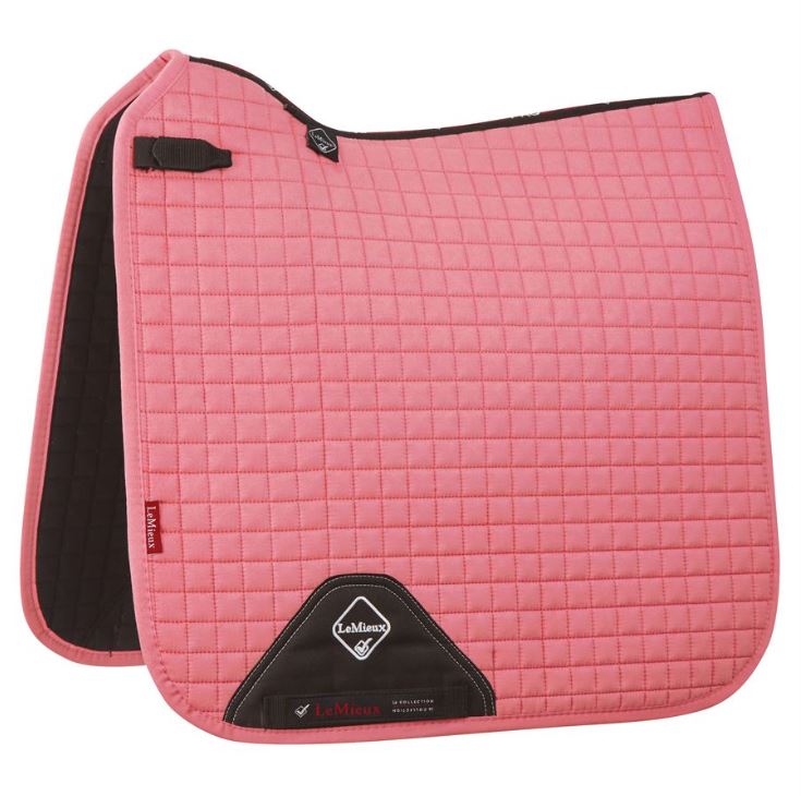A blush colored Lemieux ProSport dressage saddle pad with black lining.