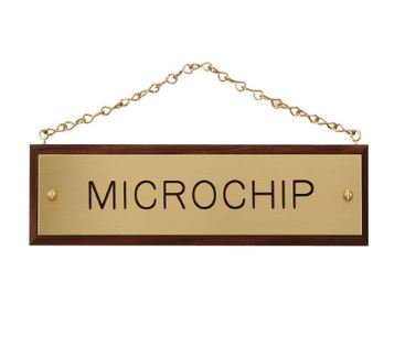 Walnut Stall Plaque with brass plate and chain. Engraved with the name "Microchip."