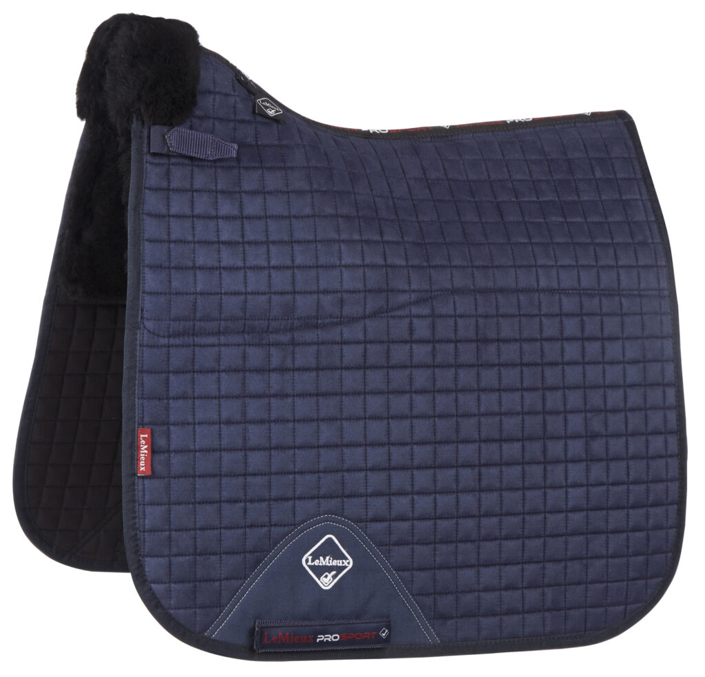 A navy blue quilted dressage saddle pad with black trim and a white LeMieux logo.
