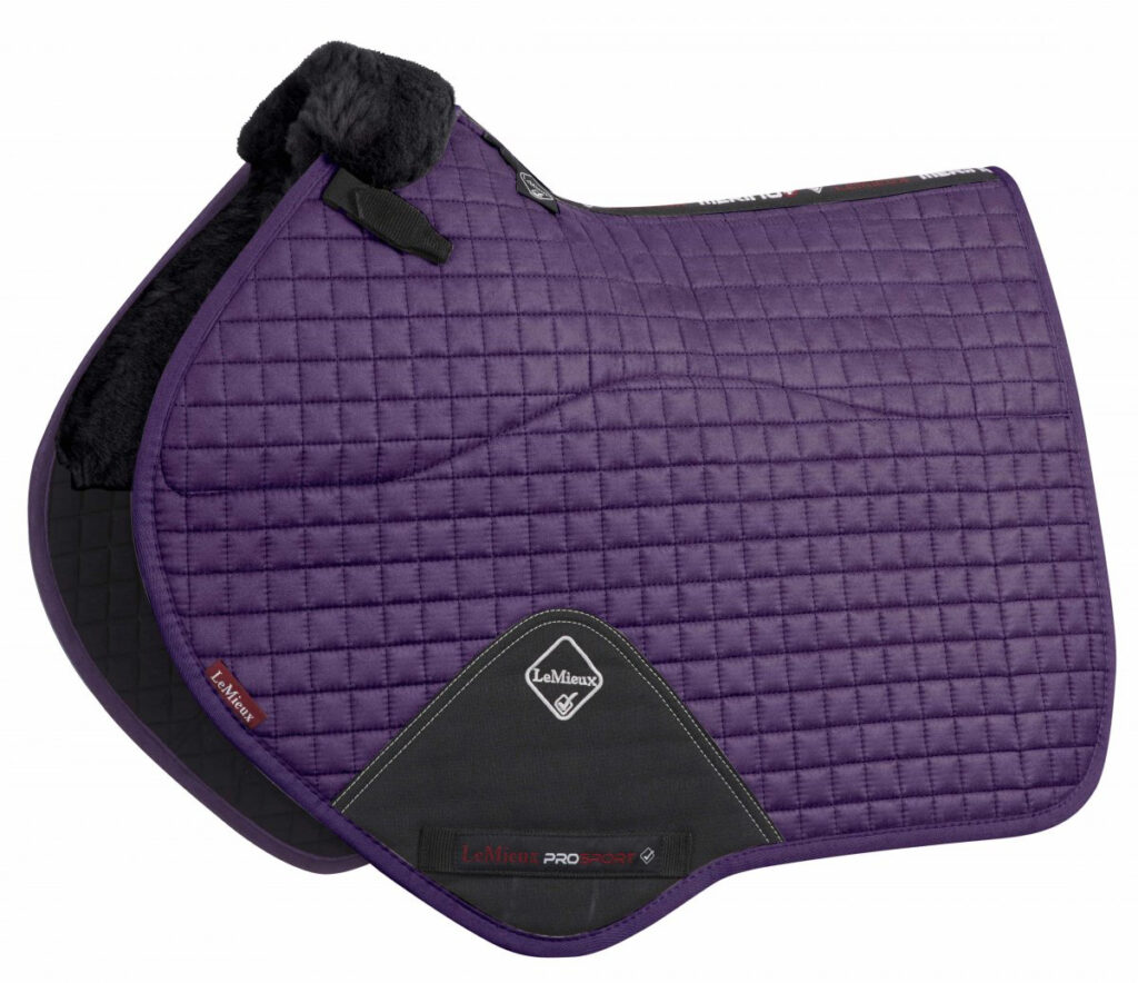 A purple quilted close contact saddle pad with black trim and a white LeMieux logo.