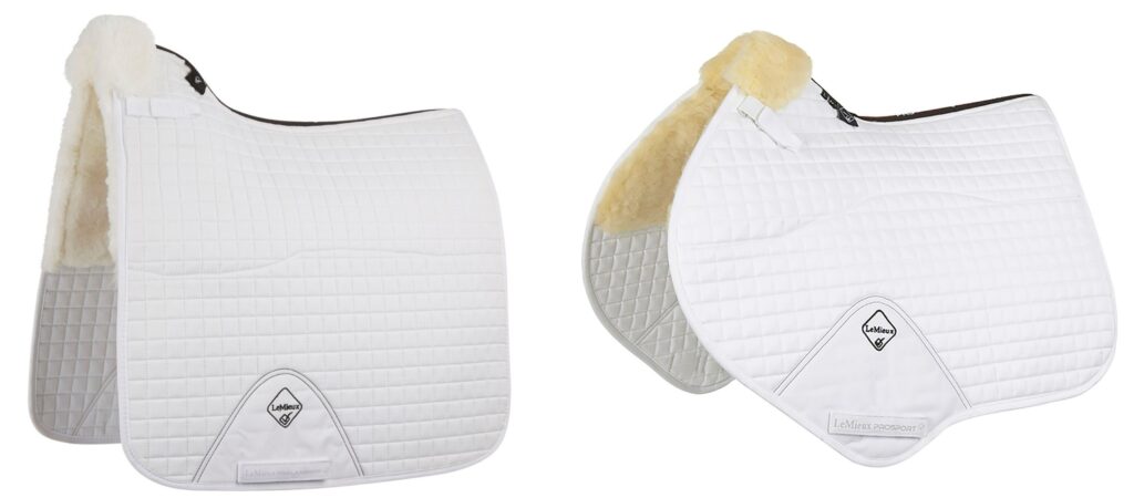 White quilted dressage saddle pad (left) and close contact saddle pad (right) with natural color wool and a black LeMieux logo.