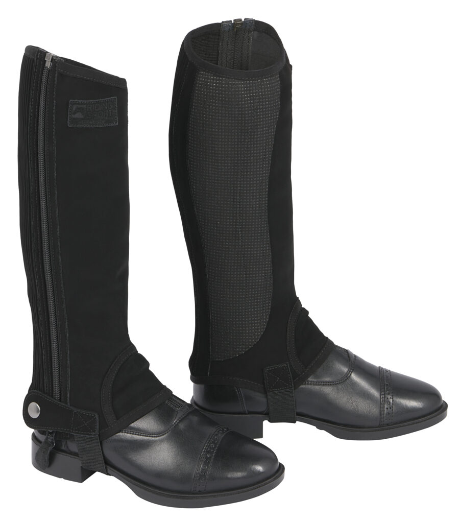 A pair of black suede half chaps and black paddock boots.